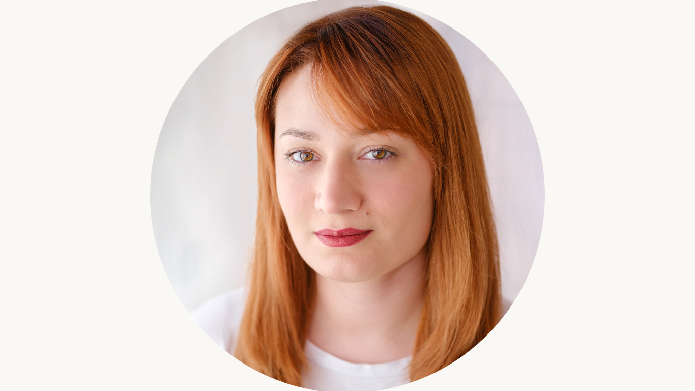 Headshot of a white woman with red hair