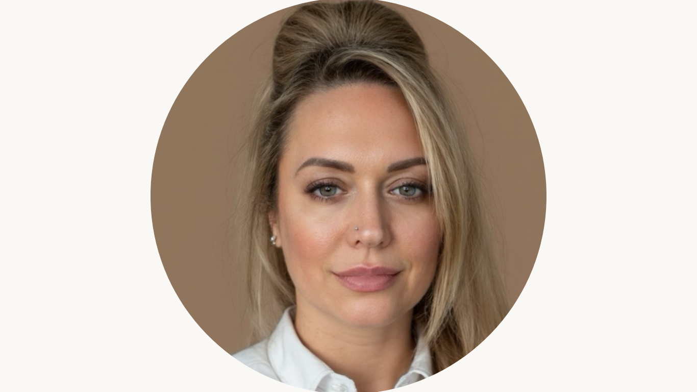 Headshot of a white woman with an up bun